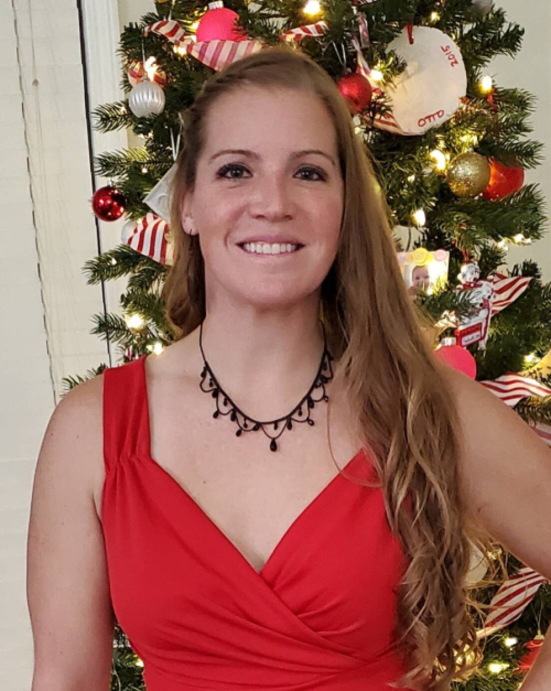 Stephanie Feeback in front of a Christmas tree